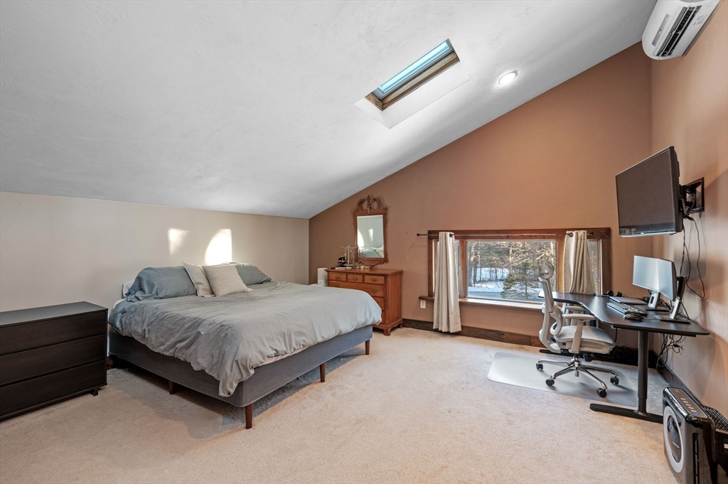 88 Squannacook Road Shirley, MA 01464 - Photo 37 of 39 a spacious bedroom with a bed a desk and chair