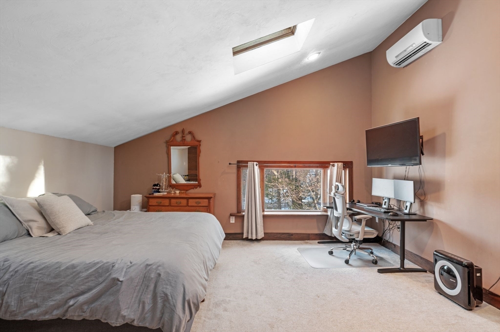 88 Squannacook Road Shirley, MA 01464 - Photo 39 of 39 a bedroom with a bed a chair and a large window