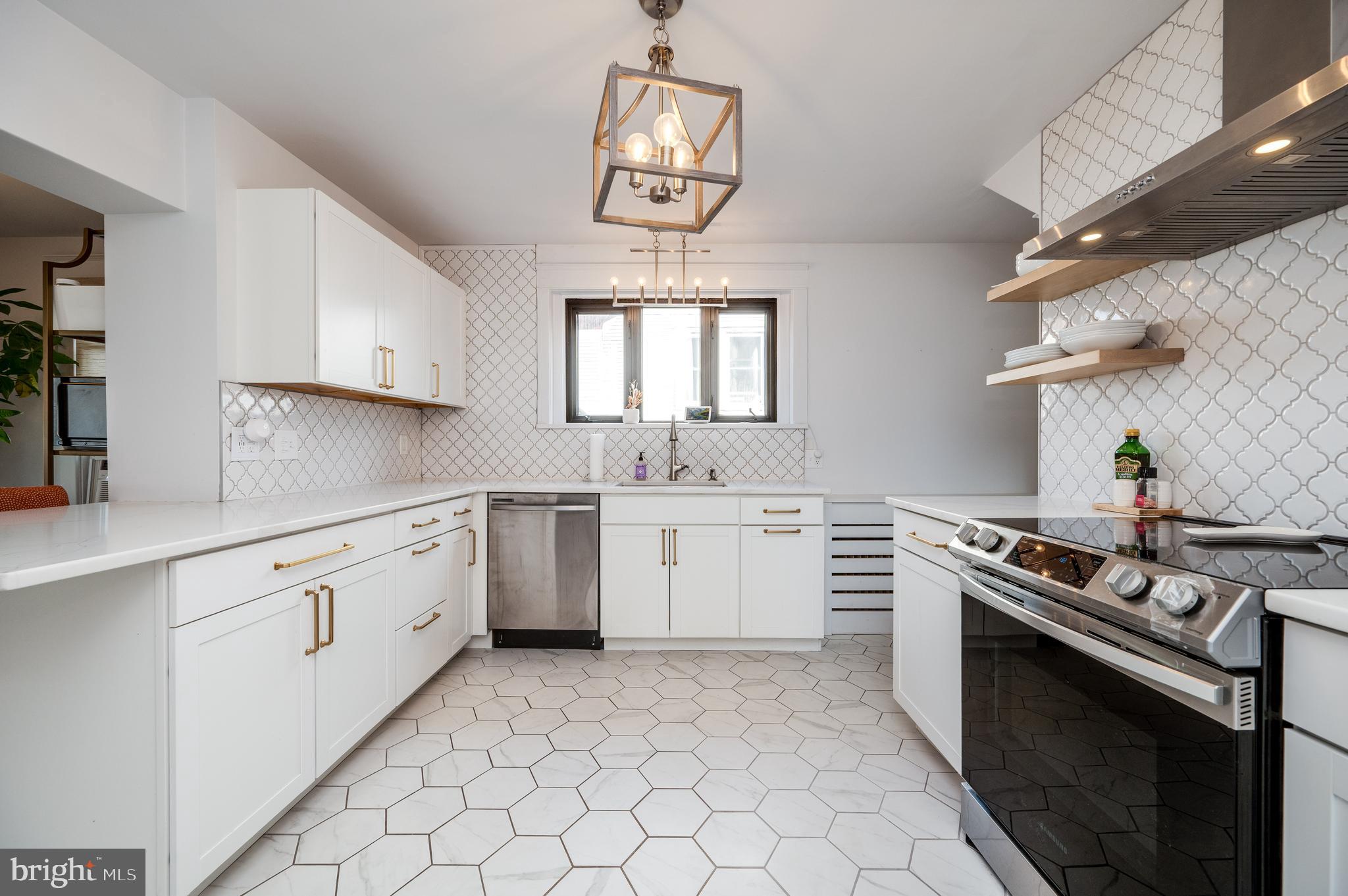 2021 Noble Street Reading, PA 19609 - Photo 17 of 54 a kitchen with a stove sink and cabinets