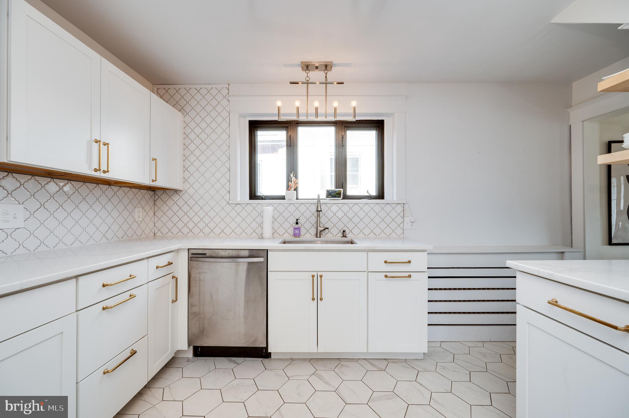 2021 Noble Street Reading, PA 19609 - Photo 19 of 54 a kitchen with white cabinets appliances a sink and a window