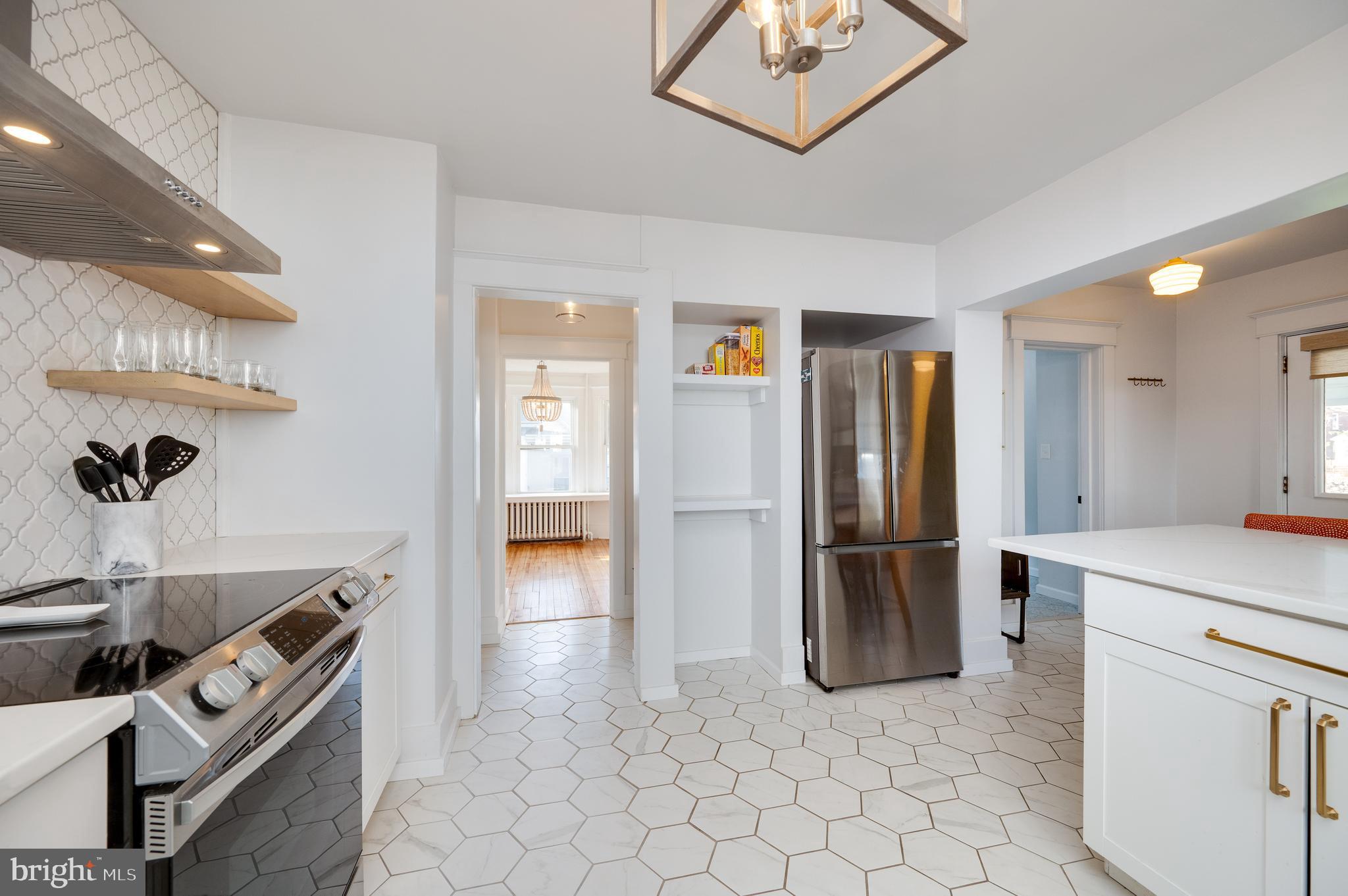 2021 Noble Street Reading, PA 19609 - Photo 22 of 54 a kitchen with granite countertop a refrigerator and a sink