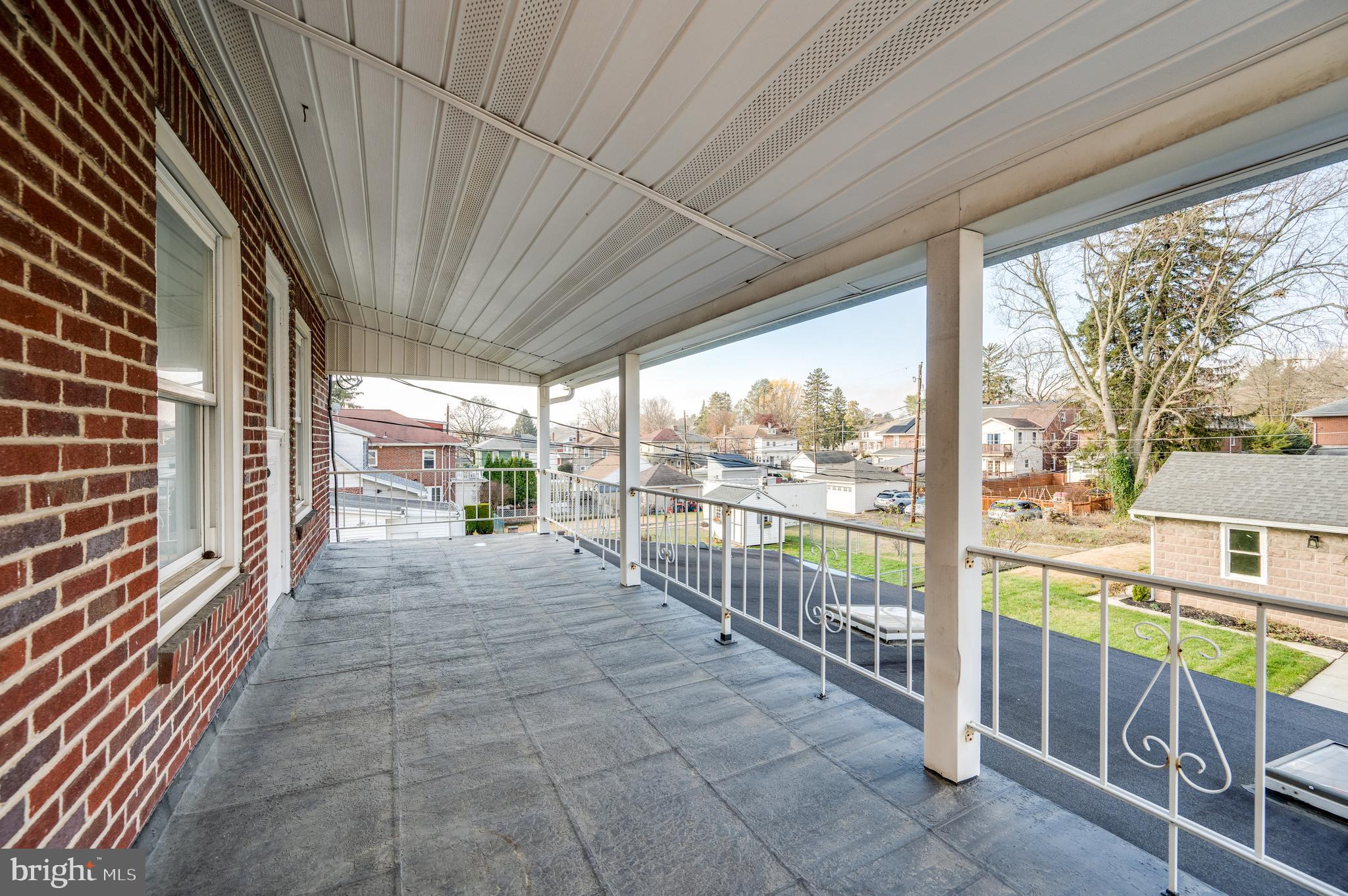 2021 Noble Street Reading, PA 19609 - Photo 32 of 54 a view of a porch with wooden floor and iron stairs