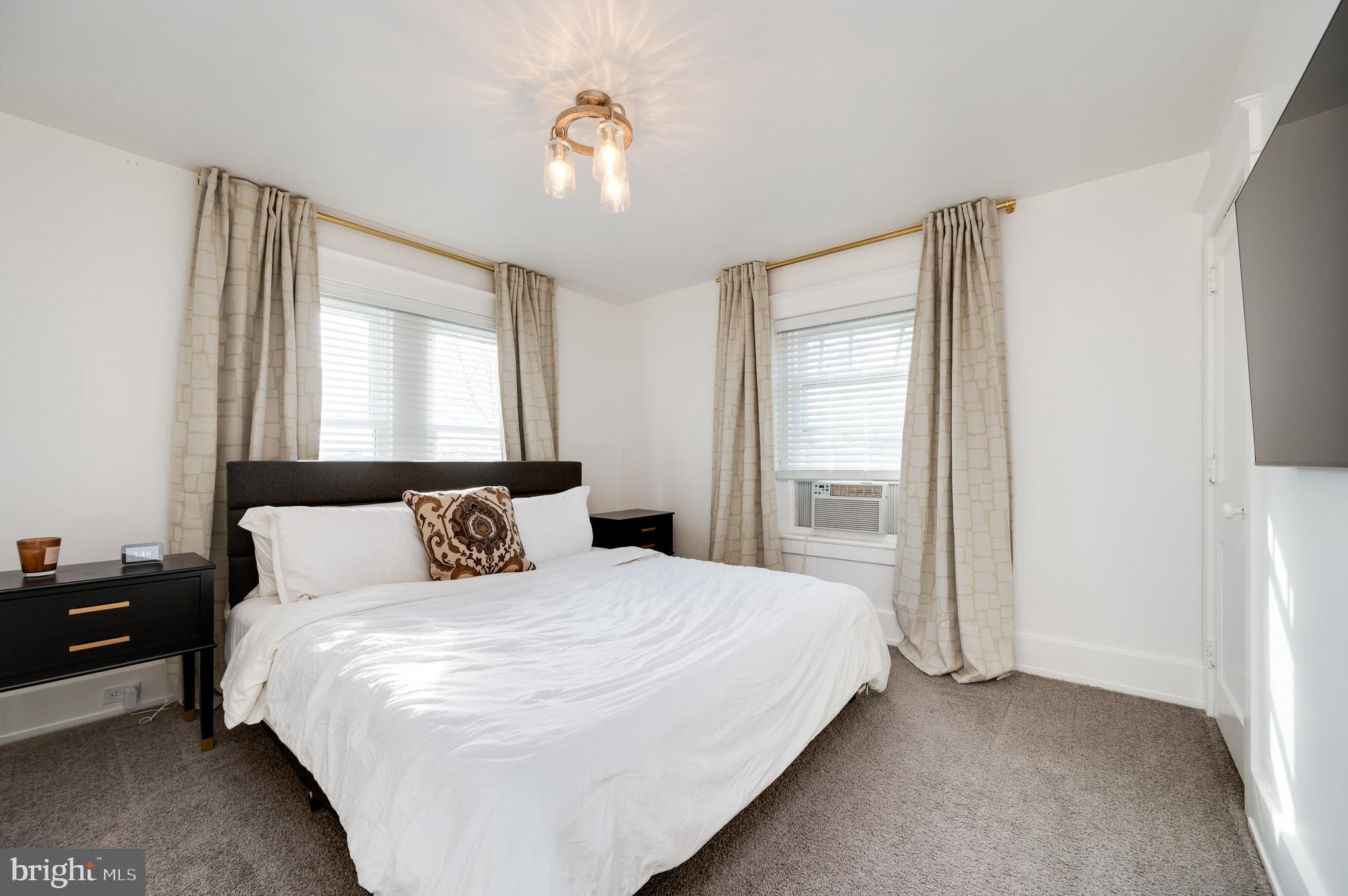 2021 Noble Street Reading, PA 19609 - Photo 35 of 54 a bedroom with a bed and a chandelier