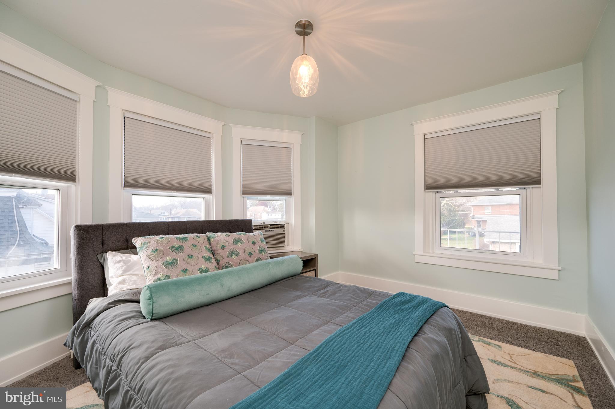 2021 Noble Street Reading, PA 19609 - Photo 37 of 54 a spacious bedroom with a bed and a window