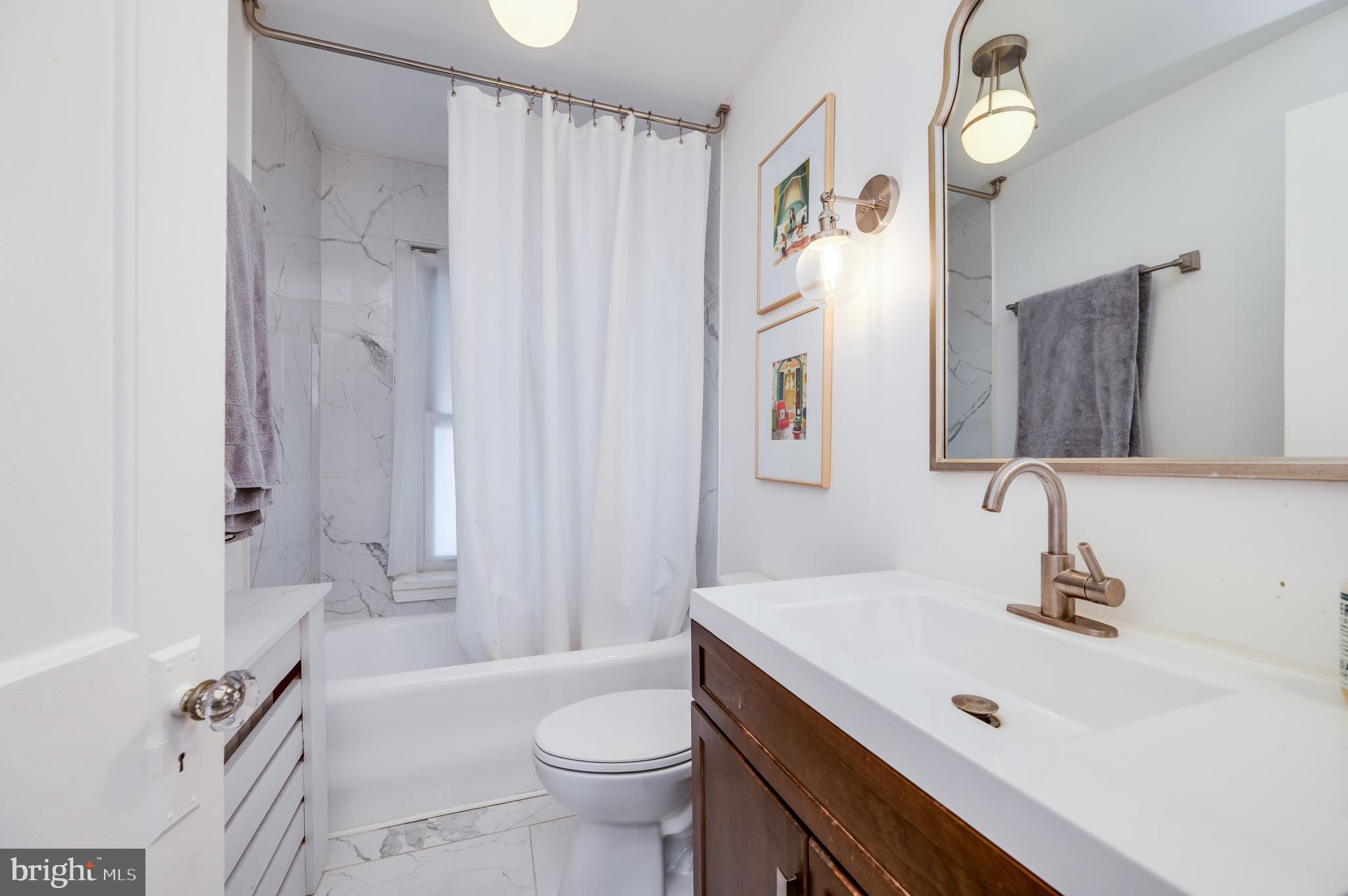 2021 Noble Street Reading, PA 19609 - Photo 39 of 54 a bathroom with a sink a toilet and a mirror