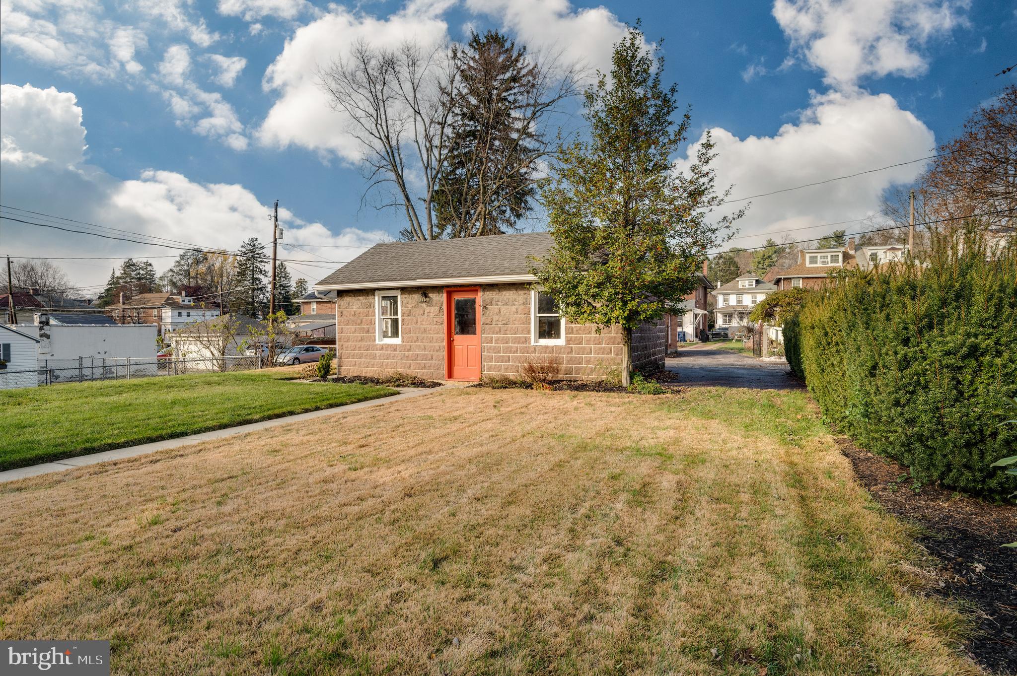 2021 Noble Street Reading, PA 19609 - Photo 45 of 54 a yellow house with trees in front of it