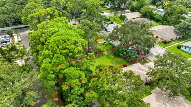 an aerial view of a house with a yard and lake view