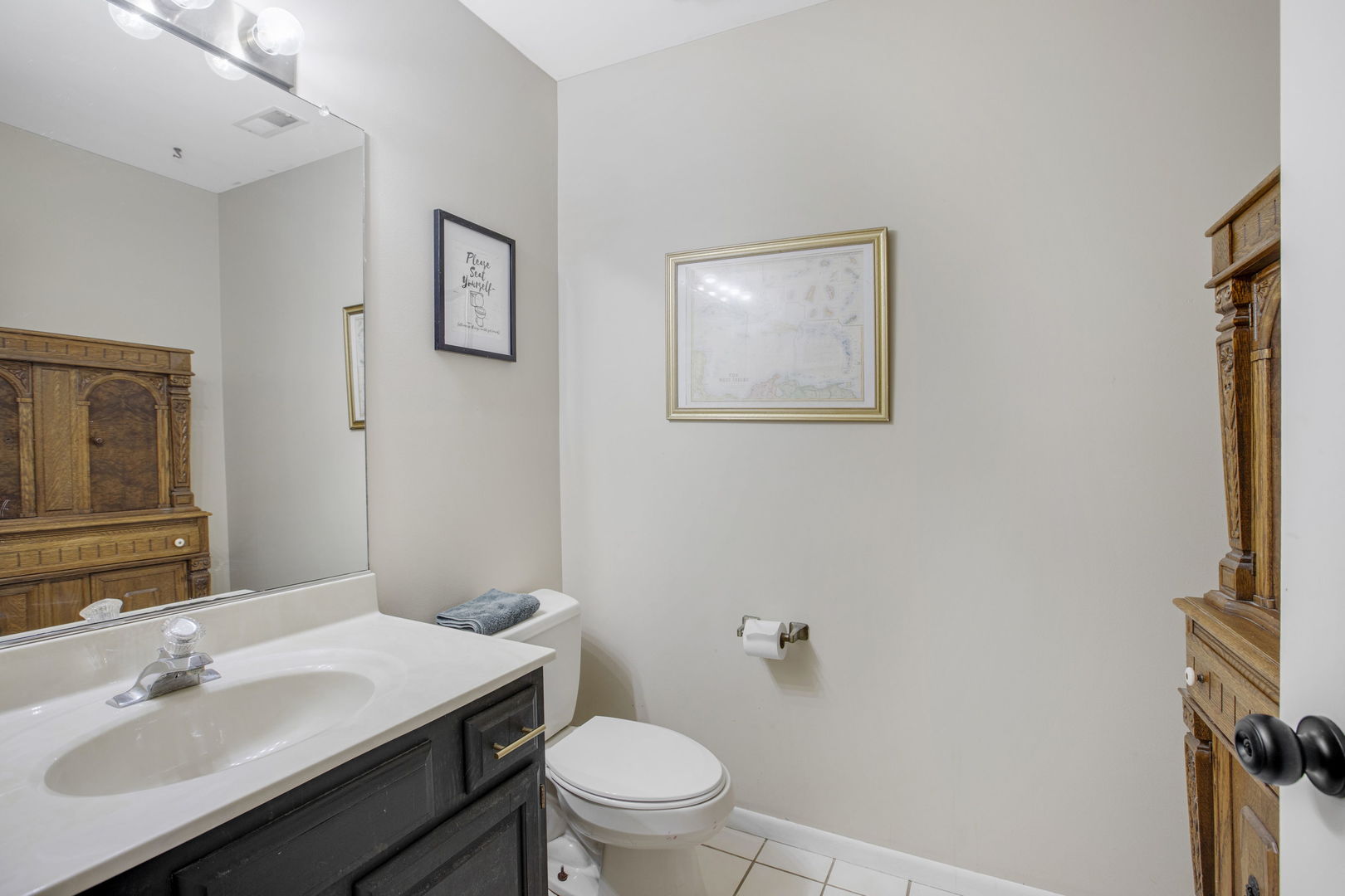 814 Roger Road Woodstock, IL 60098 - Photo 19 of 26 a bathroom with a sink toilet and a mirror