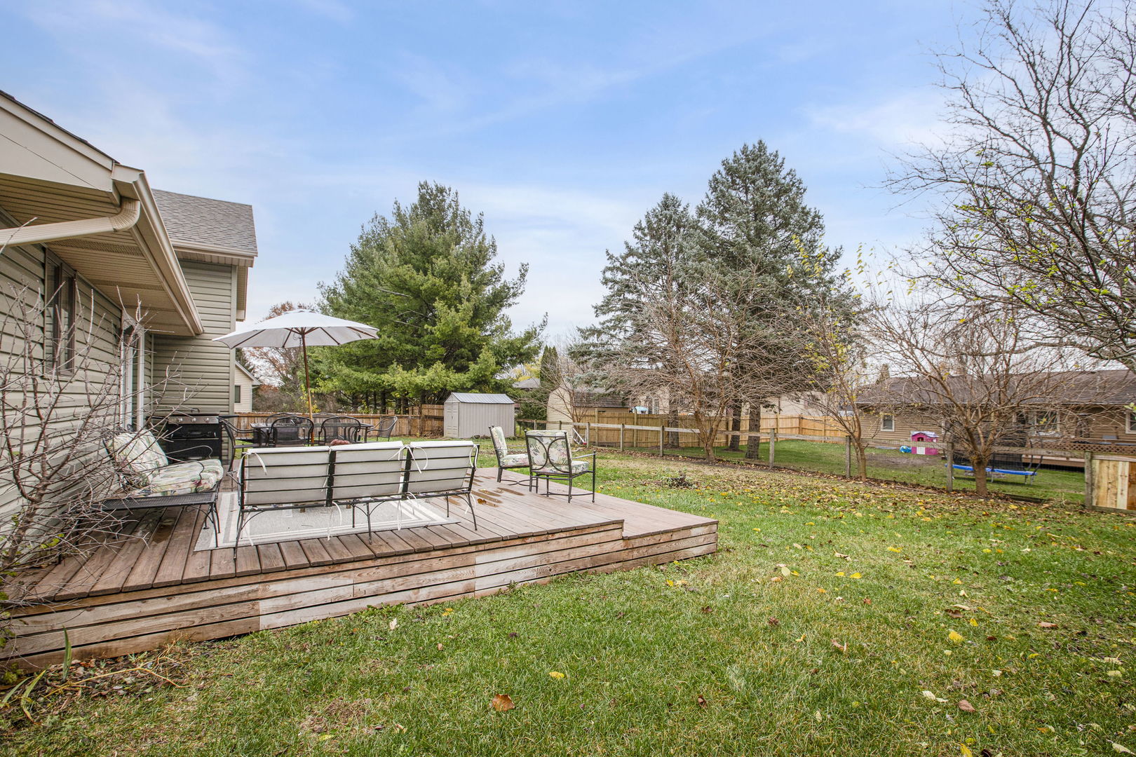 814 Roger Road Woodstock, IL 60098 - Photo 21 of 26 a view of a patio with a table and chairs with wooden fence