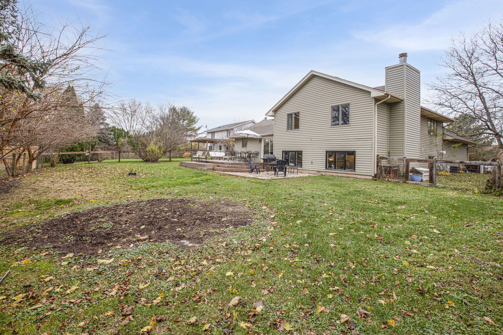814 Roger Road Woodstock, IL 60098 - Photo 23 of 26 a view of a house with a yard and sitting area