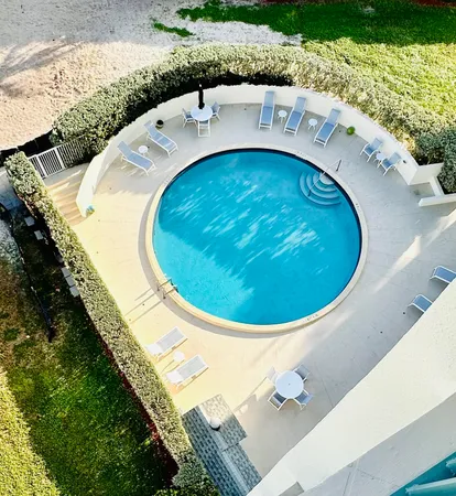 an aerial view of a house with a swimming pool