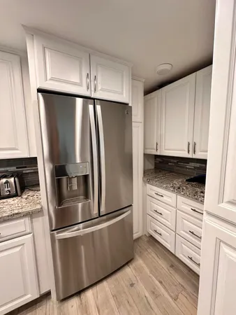 a kitchen with stainless steel appliances kitchen island granite countertop a stove a sink and a microwave
