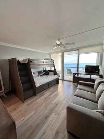 a living room with couch and wooden floor