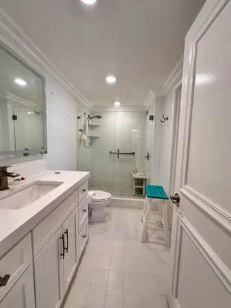 a bathroom with a toilet and a mirror