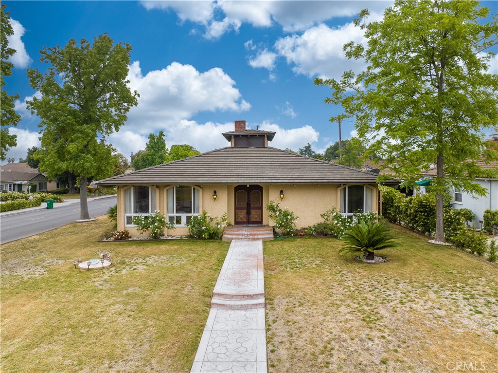 a front view of a house with garden