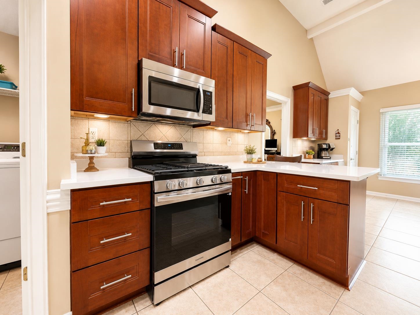 326 South Sanga Road Cordova, TN 38018 - Photo 13 of 32 Kitchen featuring wood cabinetry, stainless steel appliances, white countertops, tile backsplash, and tile flooring