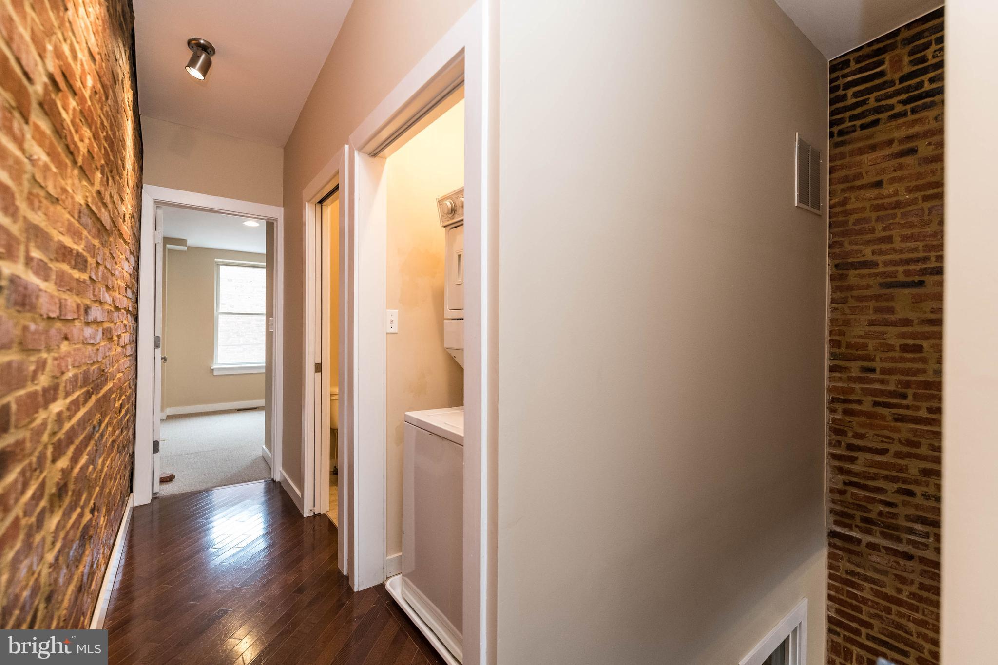 314 West 28th Street Baltimore, MD 21211 - Photo 13 of 27 a view of a hallway with wooden floor and a bathroom