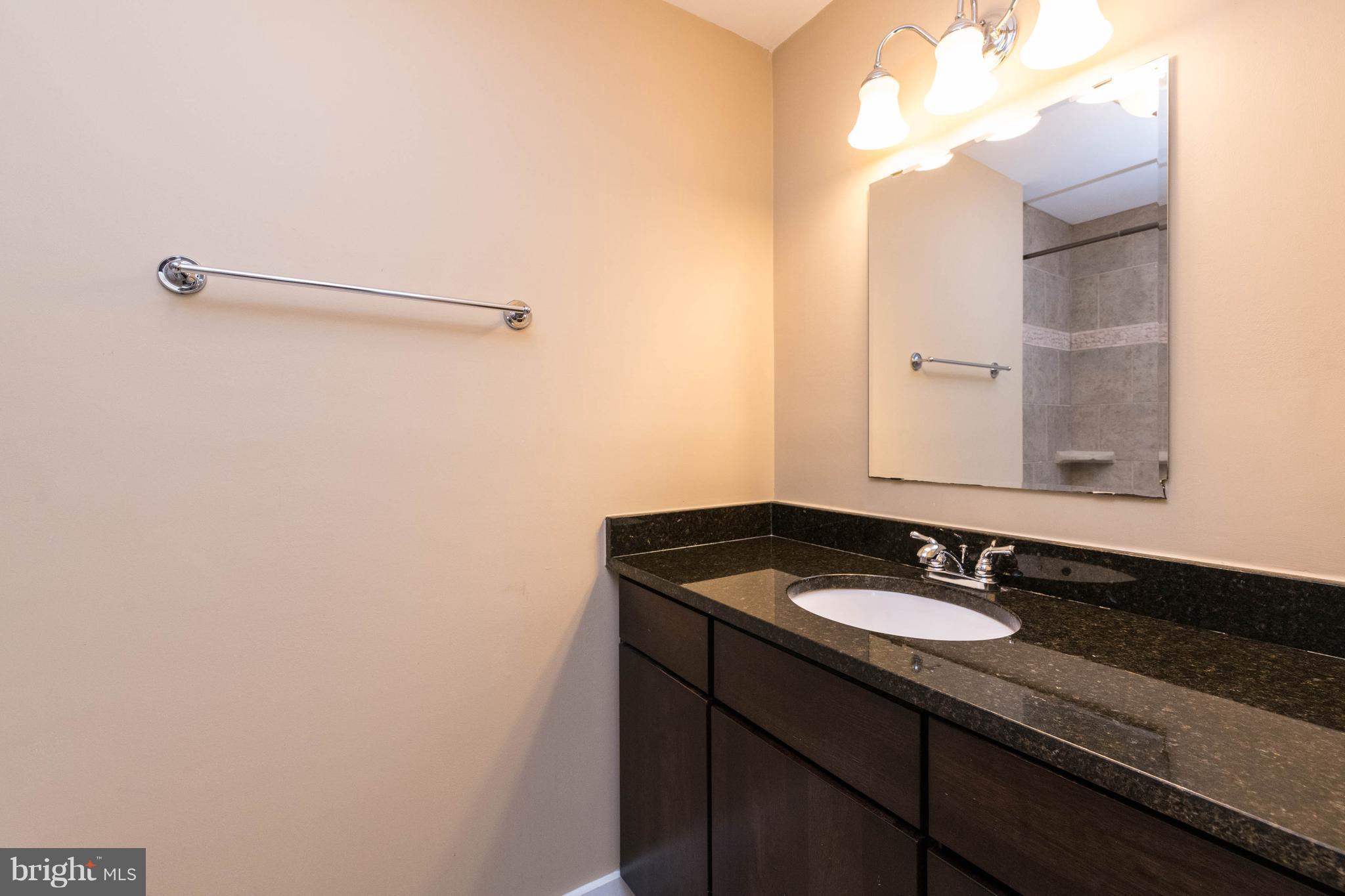 314 West 28th Street Baltimore, MD 21211 - Photo 14 of 27 a bathroom with a sink and a mirror