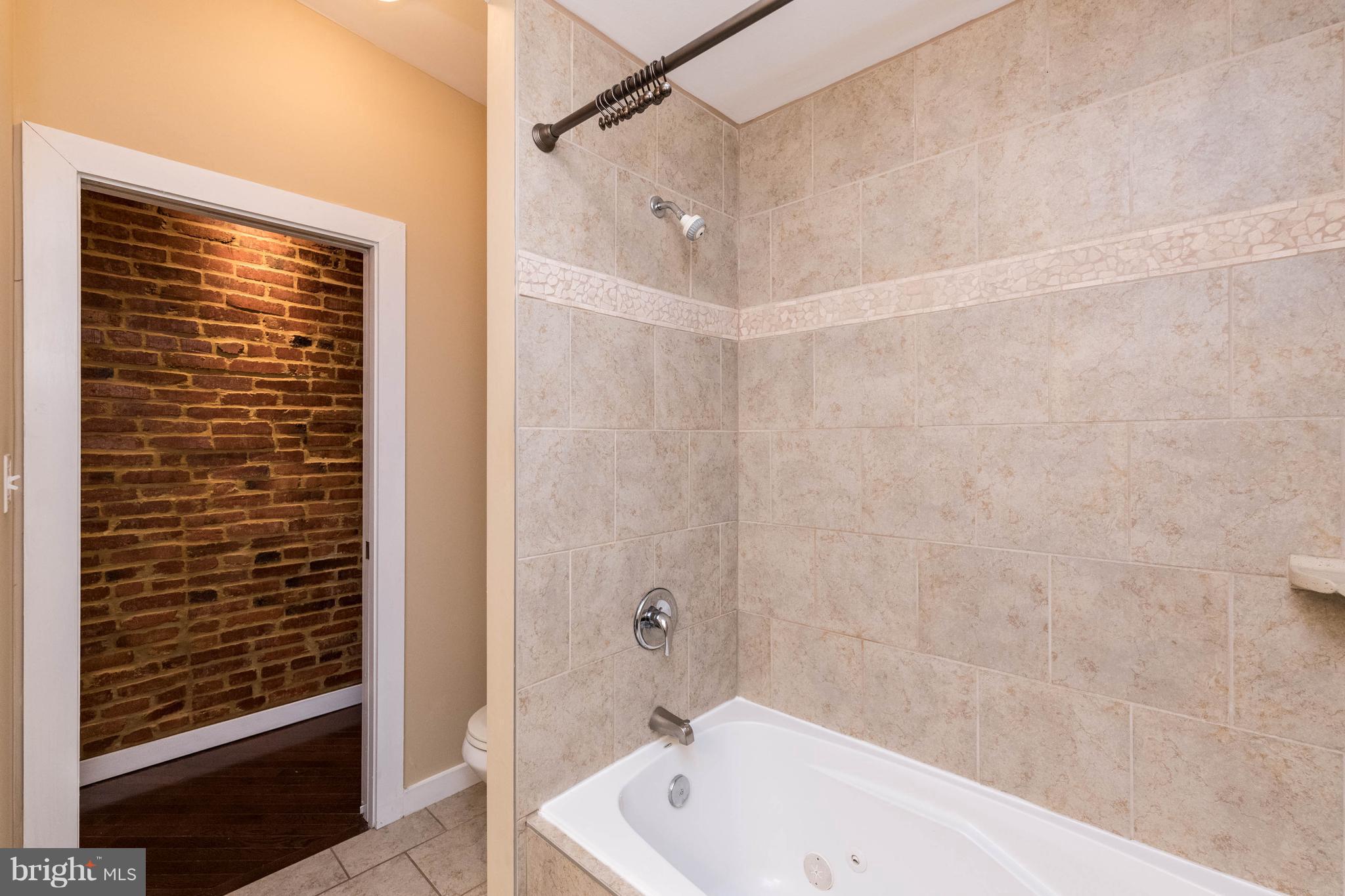 314 West 28th Street Baltimore, MD 21211 - Photo 15 of 27 a bathroom with a bathtub and shower