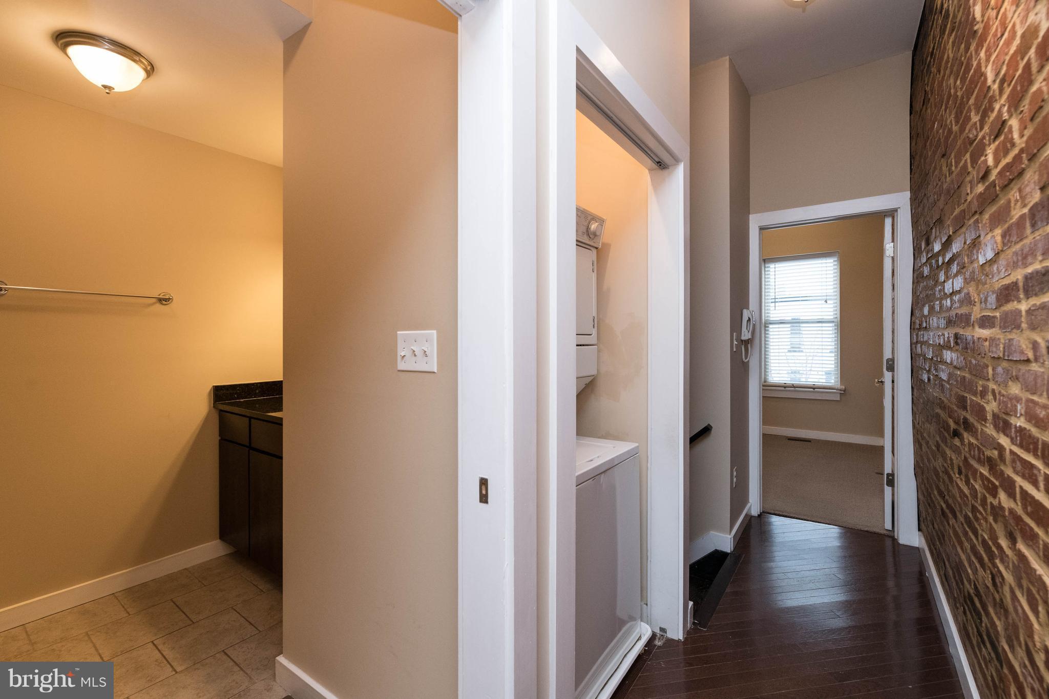 314 West 28th Street Baltimore, MD 21211 - Photo 19 of 27 a view of a hallway with wooden floor and closet