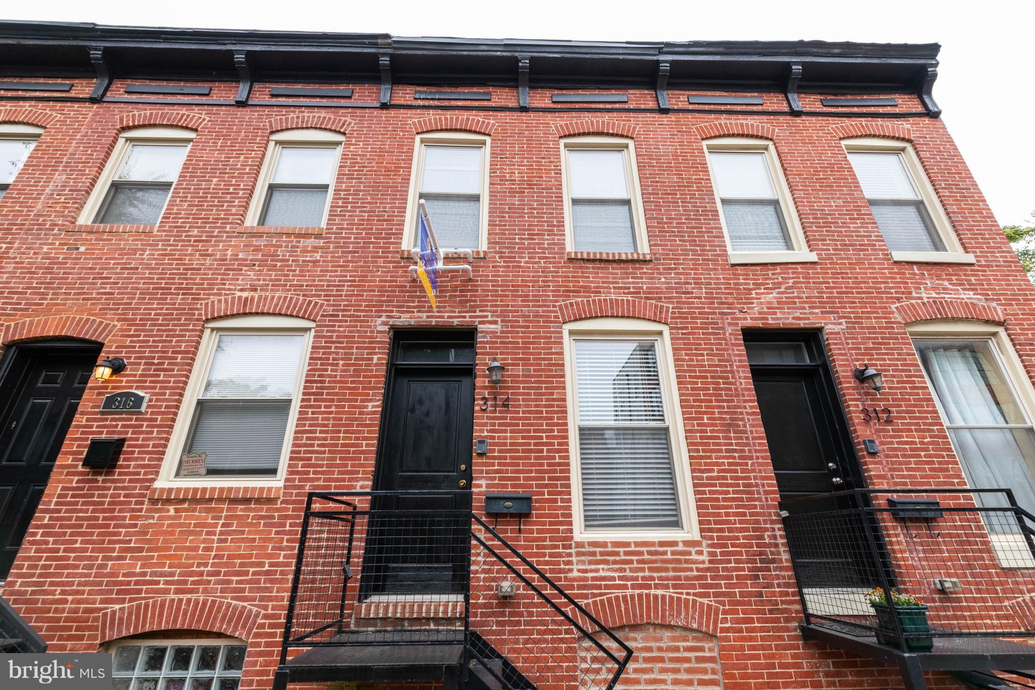 314 West 28th Street Baltimore, MD 21211 - Photo 27 of 27 a view of a brick house with a door