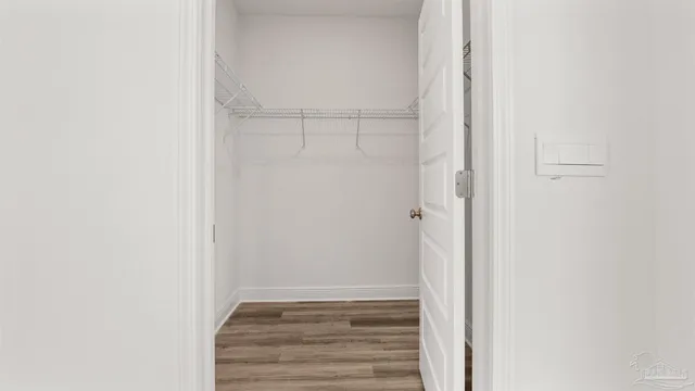 a view of an empty walk in closet with empty racks