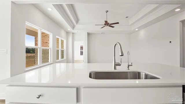 a kitchen with a sink and chandelier