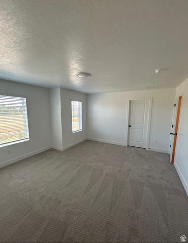 2818 West Aurora Avenue Mapleton, UT 84664 - Photo 3 of 9 Unfurnished room featuring a textured ceiling and carpet flooring