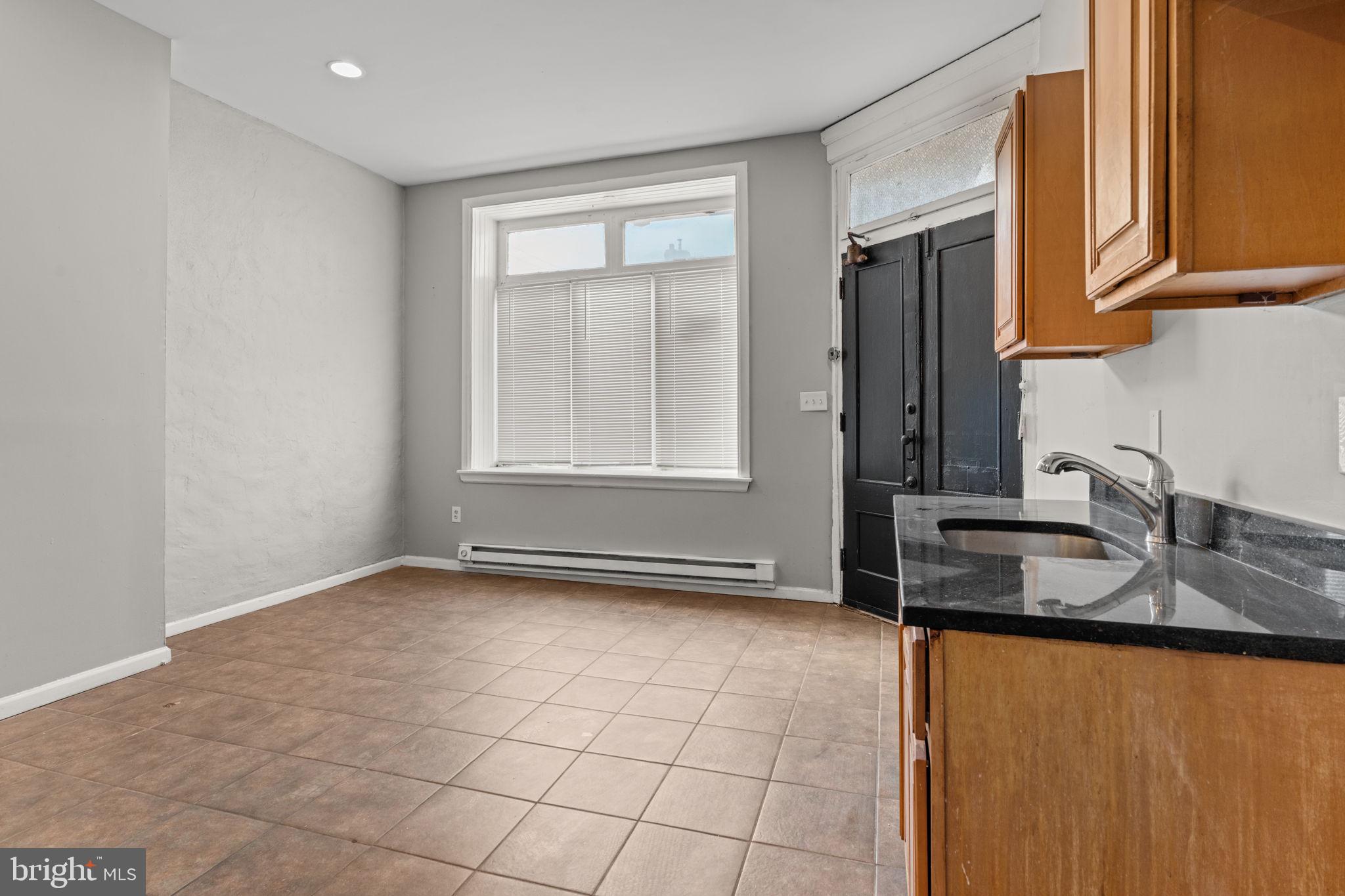 1901 East Venango Street Philadelphia, PA 19134 - Photo 14 of 29 a kitchen with granite countertop a sink and a stove top oven