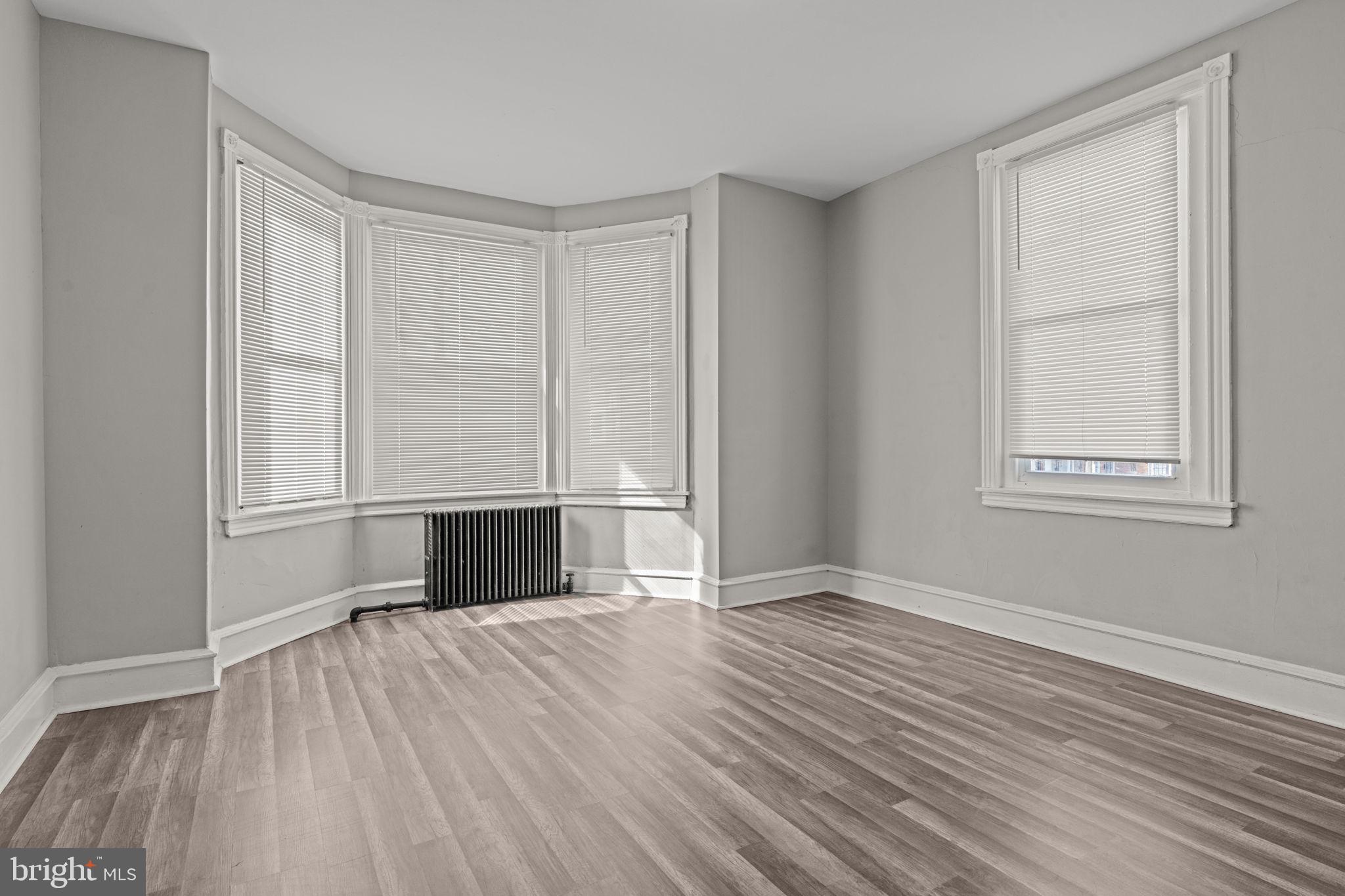 1901 East Venango Street Philadelphia, PA 19134 - Photo 17 of 29 wooden floor in an empty room with a window