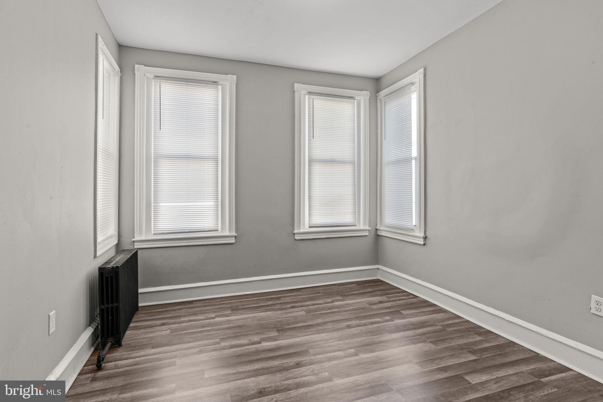1901 East Venango Street Philadelphia, PA 19134 - Photo 21 of 29 wooden floor in an empty room with a window