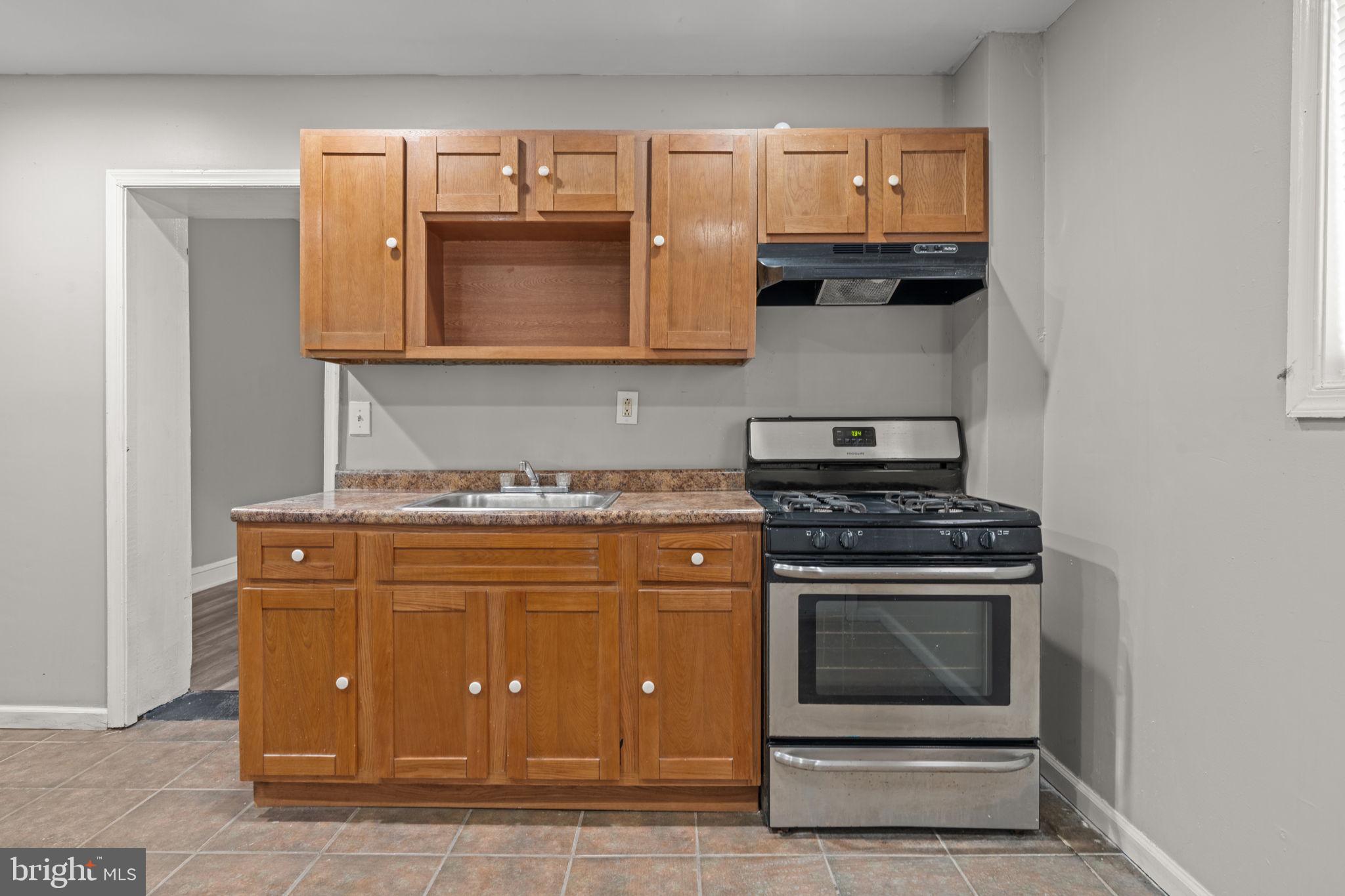 1901 East Venango Street Philadelphia, PA 19134 - Photo 10 of 29 a stove top oven sitting inside of a kitchen