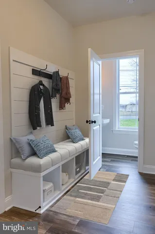a living room with furniture and a walk in closet