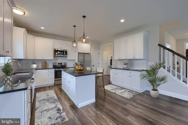 a kitchen with white cabinets and counter space