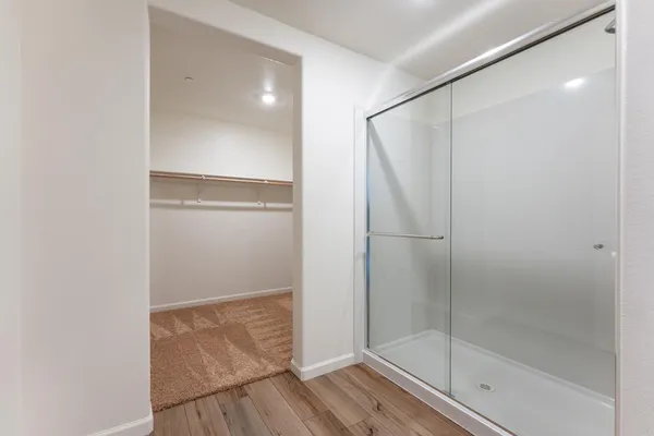 a bathroom with a glass shower door