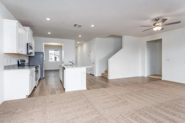 a view of a kitchen with kitchen island a counter top space appliances and cabinets