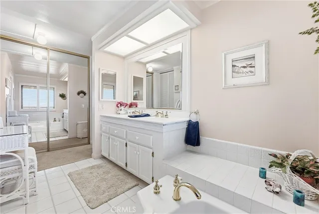 a bathroom with a tub sink and mirror