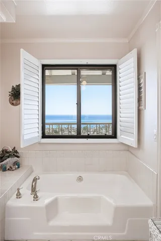 a bathroom with a bathtub and window