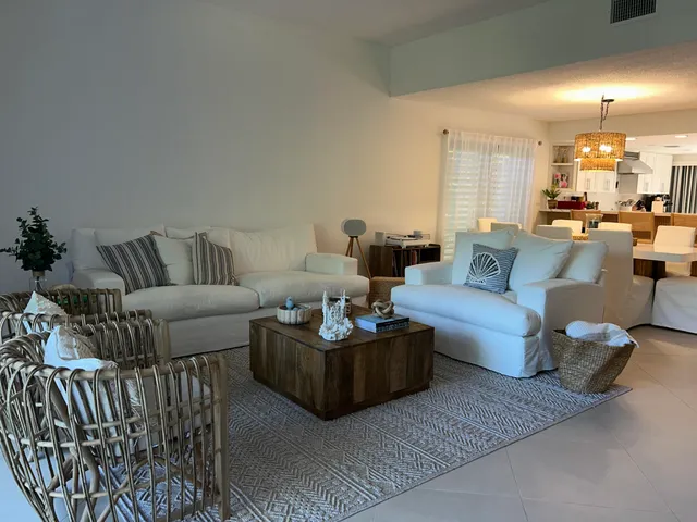 a kitchen with stainless steel appliances a stove a sink and white cabinets
