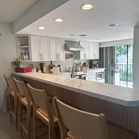 a kitchen with stainless steel appliances granite countertop a sink and cabinets