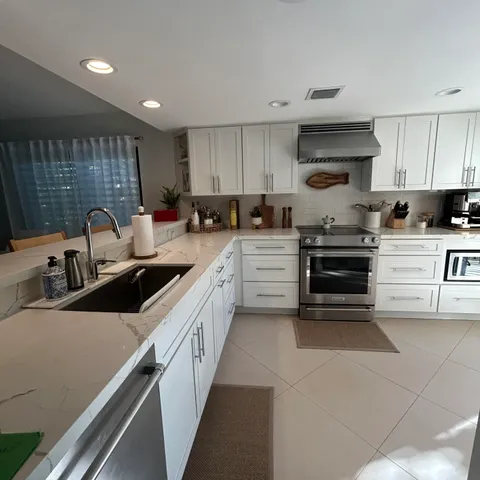 a living room with furniture and a painting on the wall