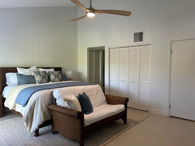 a bathroom with a granite countertop toilet a sink and a large mirror