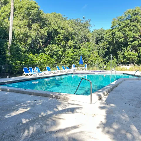 a view of a patio with table and chairs under an umbrella