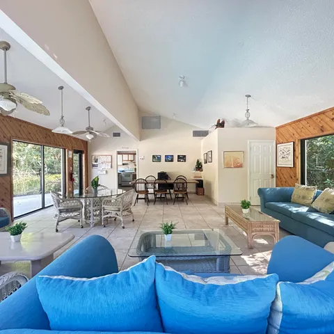 a living room with fireplace furniture and a large window