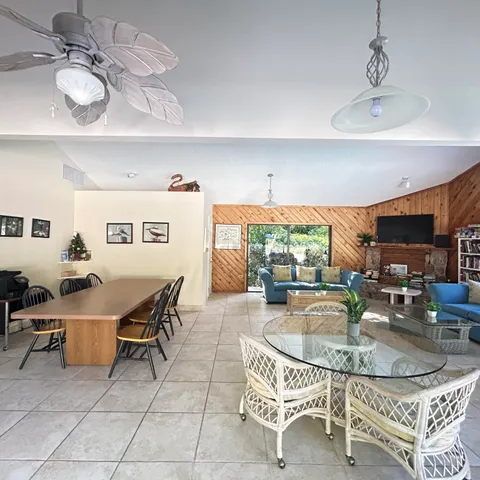 a backyard of a house with table and chairs