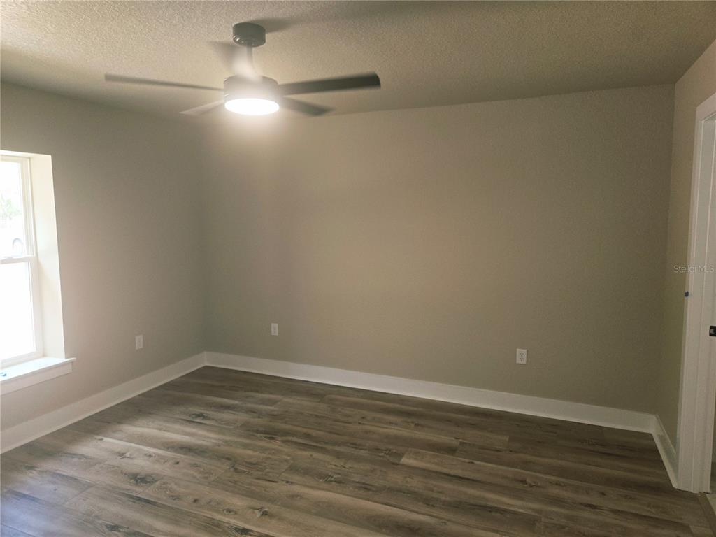 8541 Northeast 105th Avenue Bronson, FL 32621 - Photo 14 of 20 wooden floor in an empty room