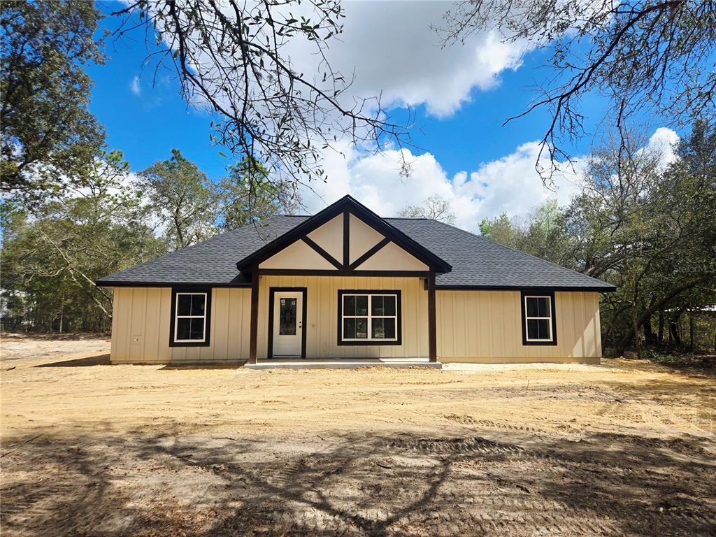 8541 Northeast 105th Avenue Bronson, FL 32621 - Photo 2 of 20 a house with trees in the background