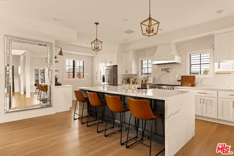 a large kitchen with a table and chairs in it