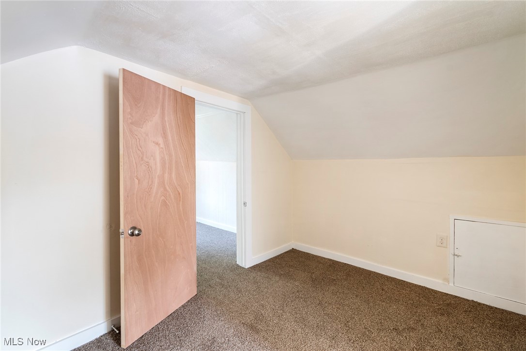 8131 Struthers Road Lowellville, OH 44436 - Photo 29 of 48 Additional living space with lofted ceiling and carpet flooring
