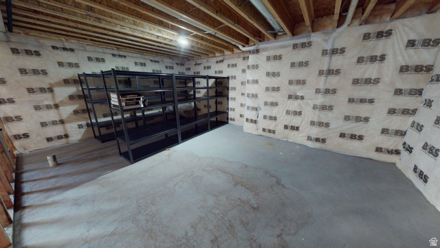 5502 North Valley View Road Lehi, UT 84048 - Photo 27 of 33 Unfinished basement featuring exposed wood joists, concrete flooring, and insulated walls